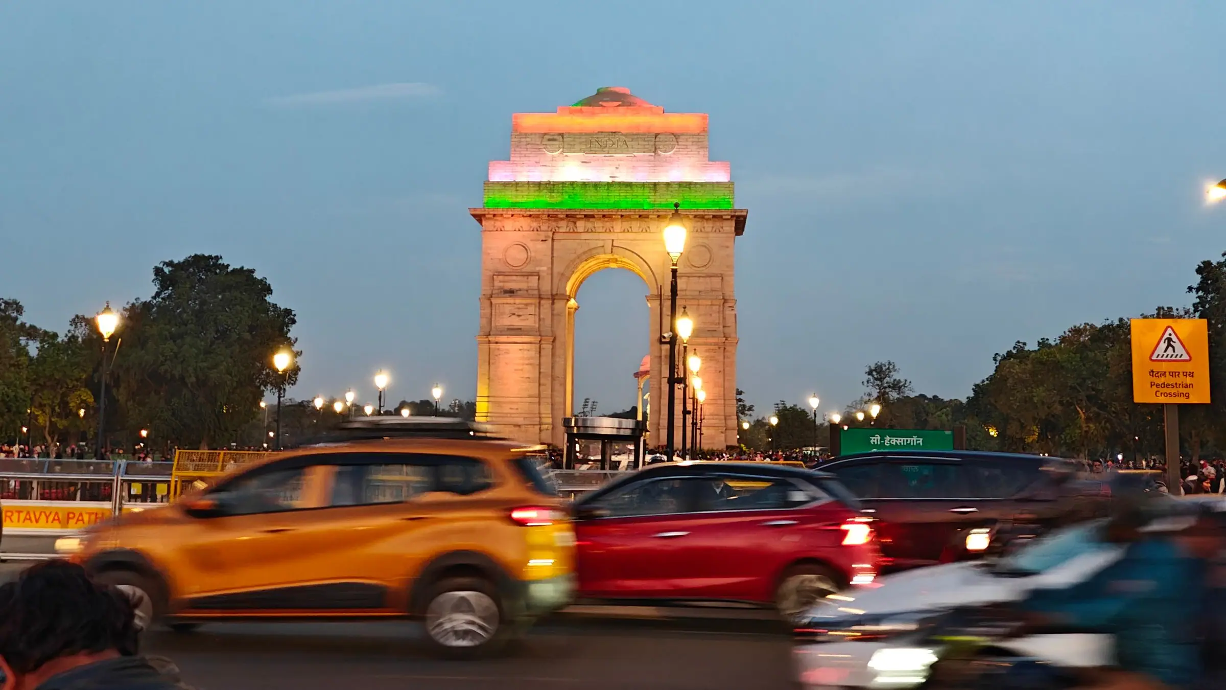 Cabs passing India Gate in Delhi in the evening
