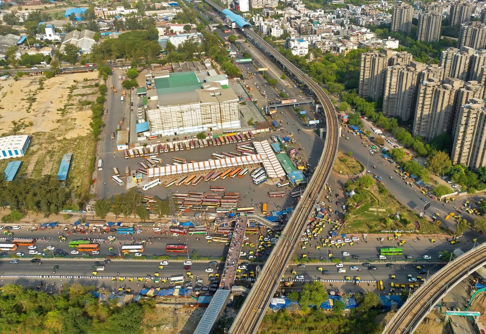 Aerial view of a metro line, roads and high-rise societies